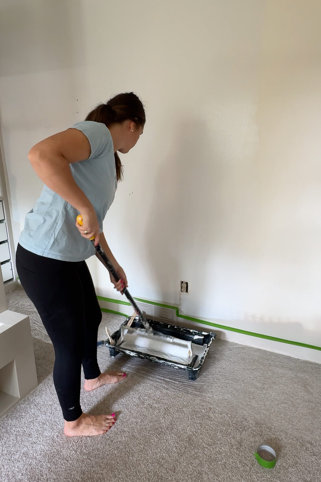 Priming the wall before installing wall paper.